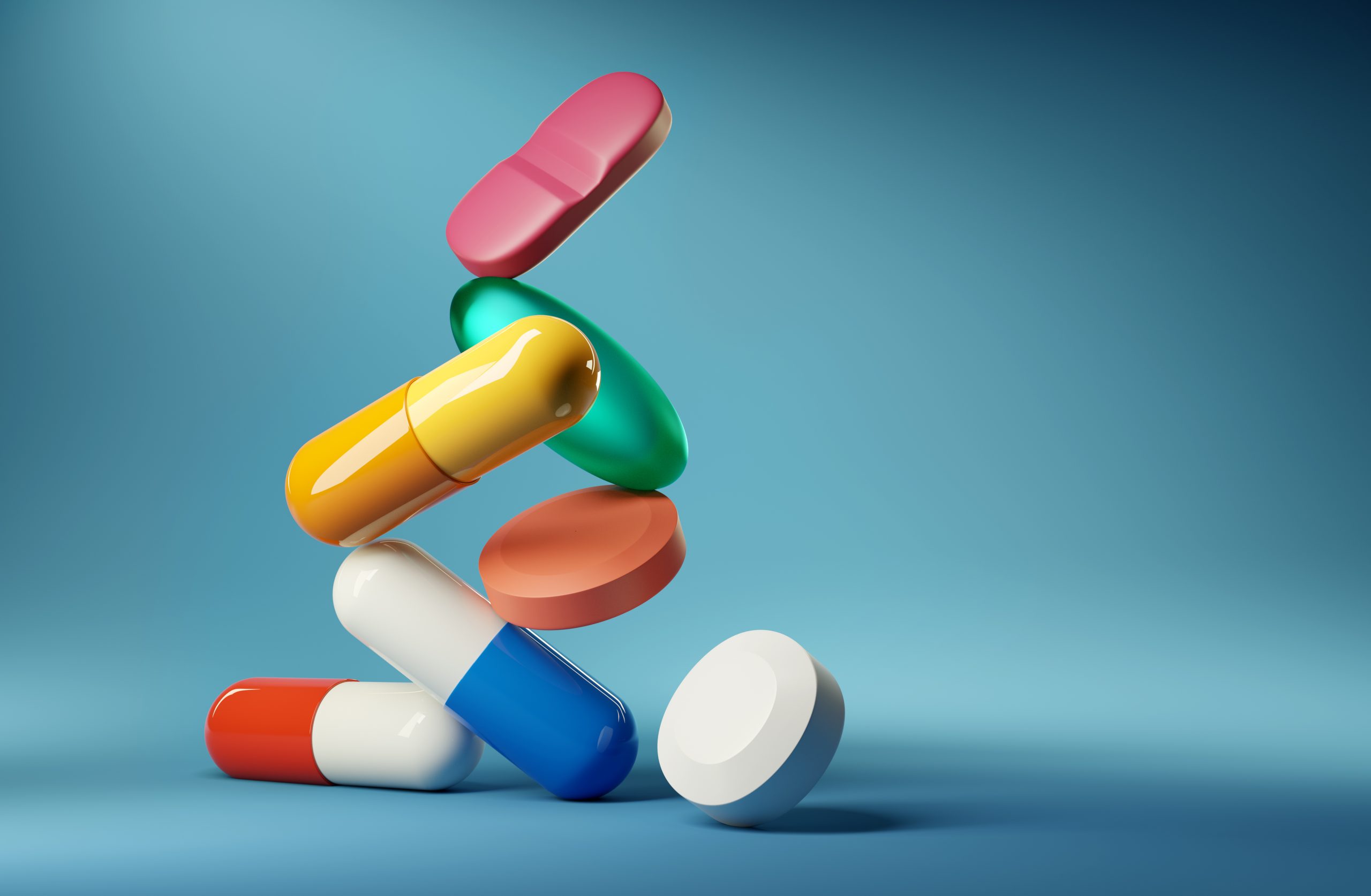 a variety of colorful pills, including capsules and tablets, representing medications often linked with substance use disorders and dual diagnosis in individuals with severe mental illness